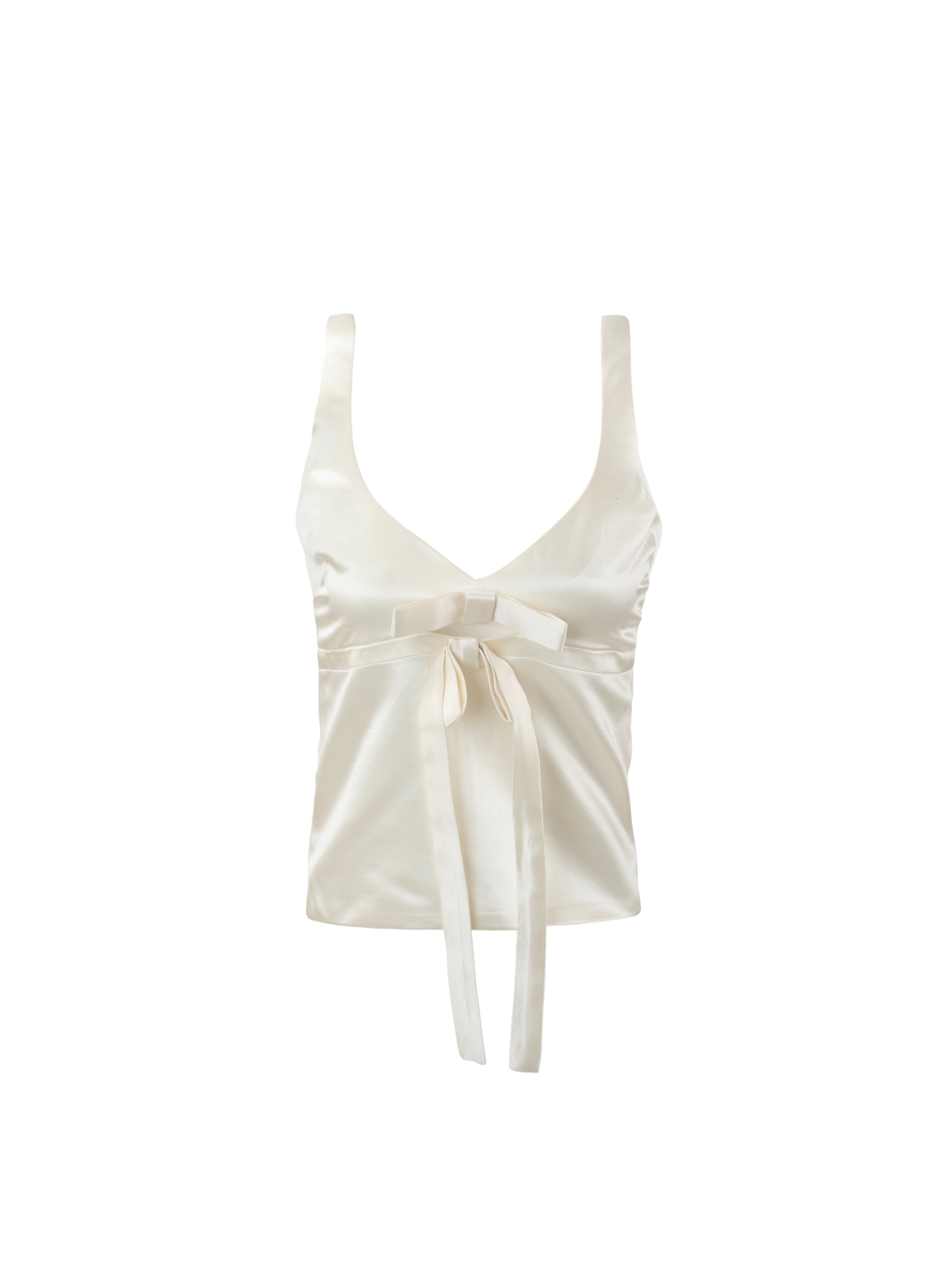 White sleeveless top with a bow detail on a white background