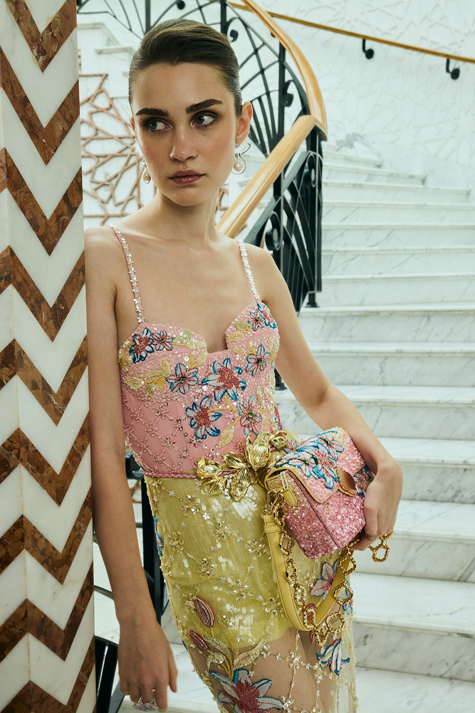 Luxury vacation wear featuring a fitted party dress with hand-embroidered floral motifs