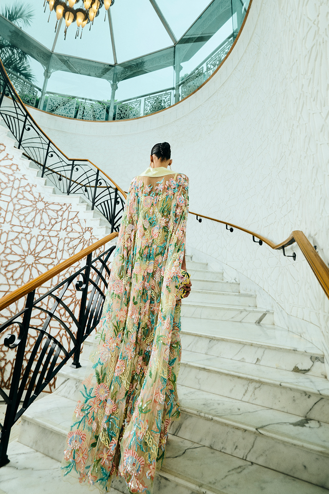 Evening gown styled with a fitted cocktail party cape featuring hand-embroidered floral motifs for a luxury event outfit