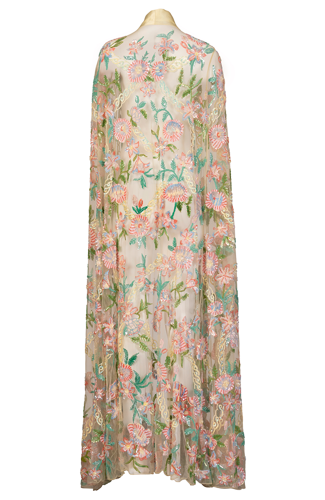 Evening gown layered with a beaded cocktail party cape for a refined guest of the wedding outfit