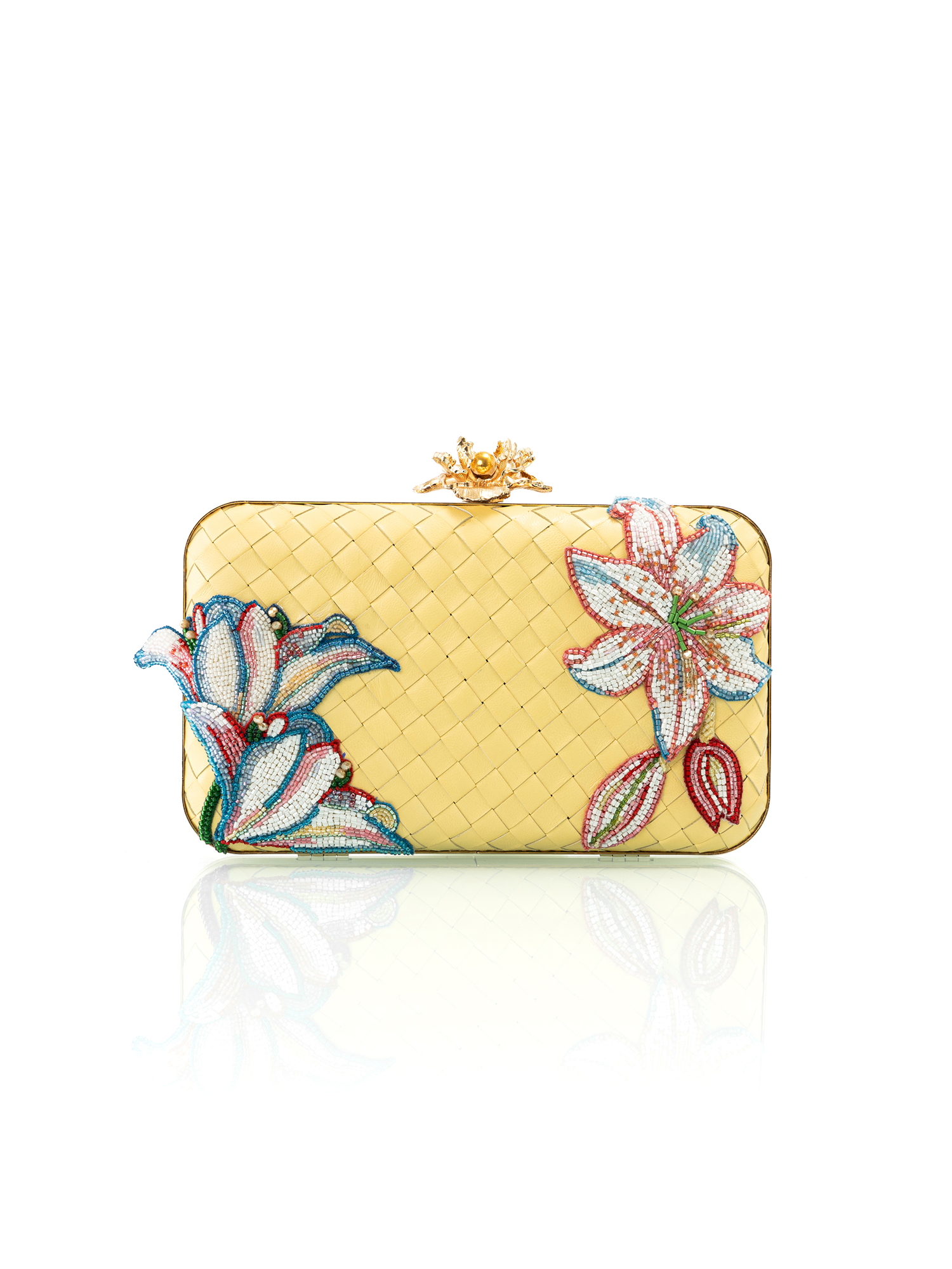 Yellow clutch bag with floral embroidery on a white background