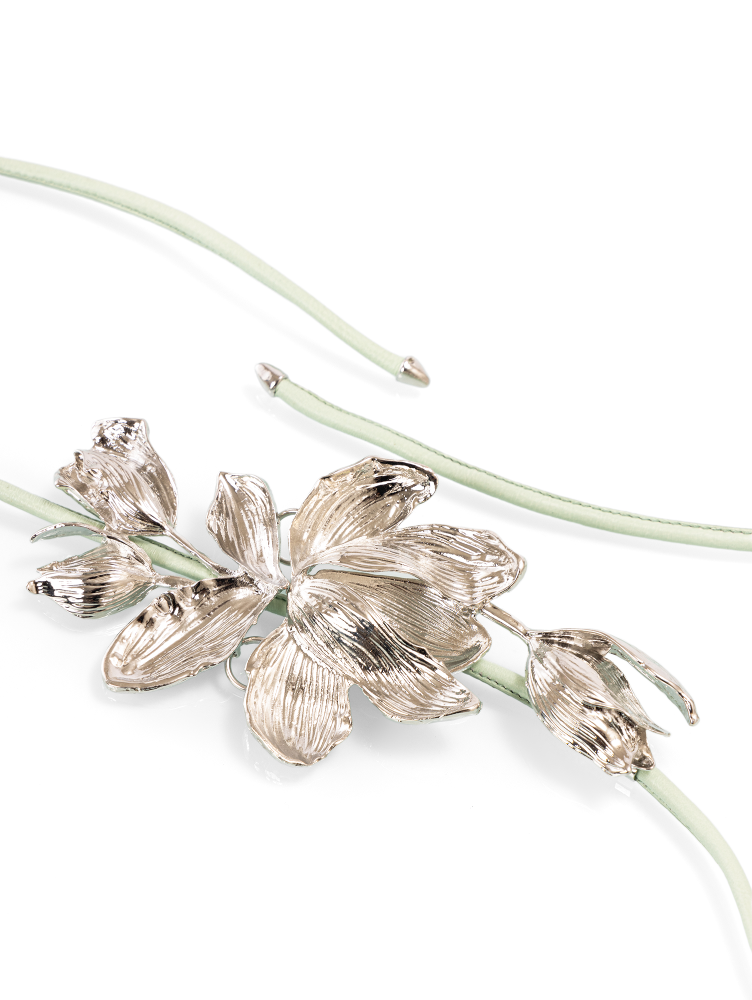 Sculptural belt featuring a delicate metal flower buckle designed to add a refined waist accent