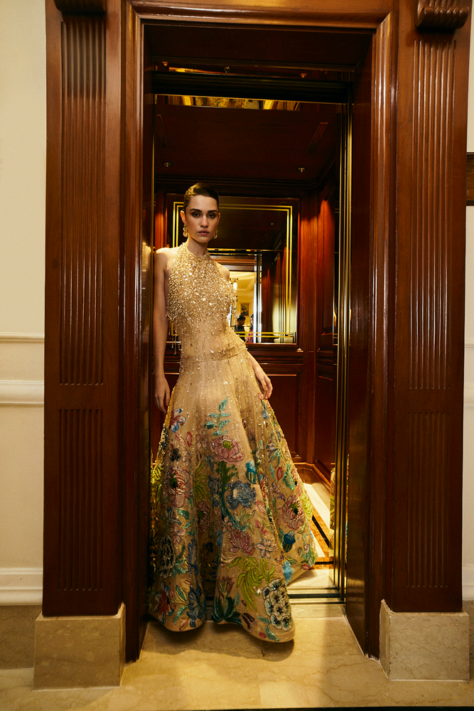 Full length gown styled as a wedding guest gown with elegant beaded dress detailing