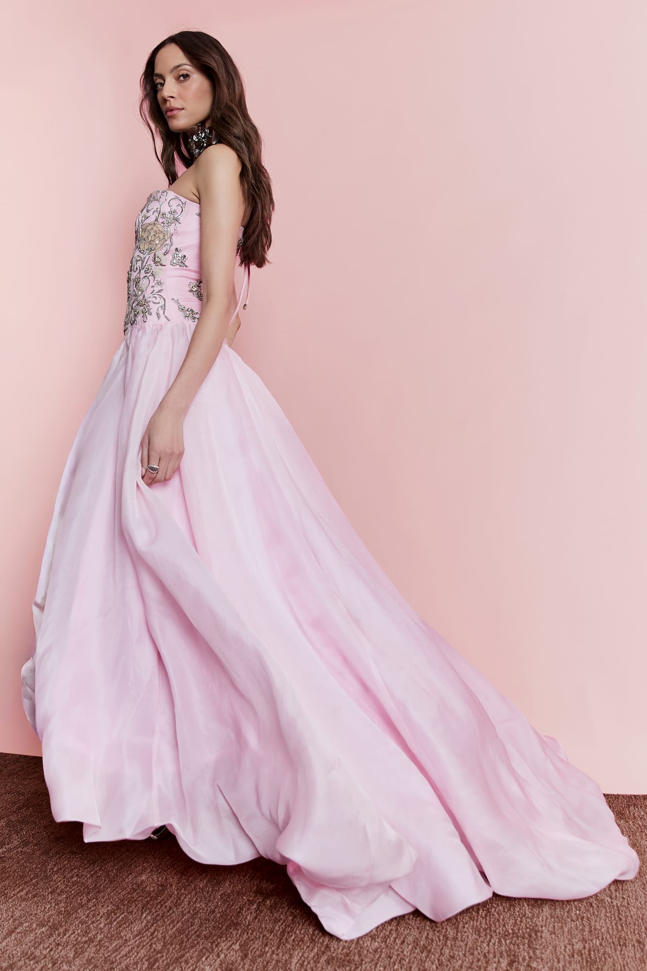Luxury pink gown with hand-embellished strapless design, shimmering floral embroidery for couture gala attire