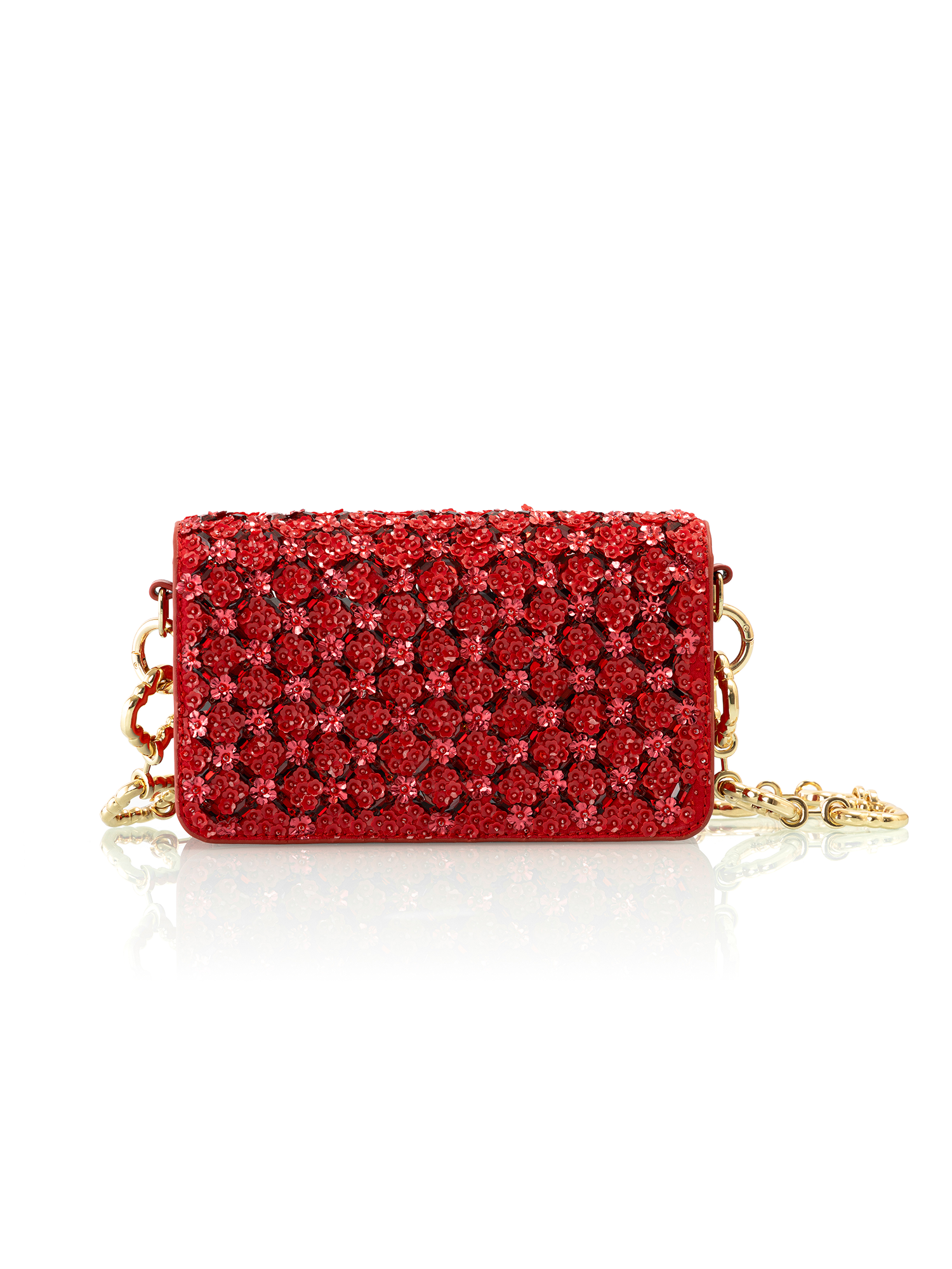 Crimson handcrafted leather bag styled as a luxurious red and gold evening statement
