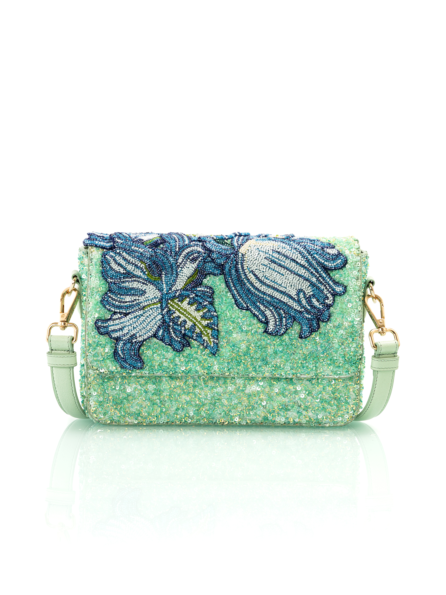 Floral embroidered leather bag handcrafted by artisan based brands for luxury resort wear styling
