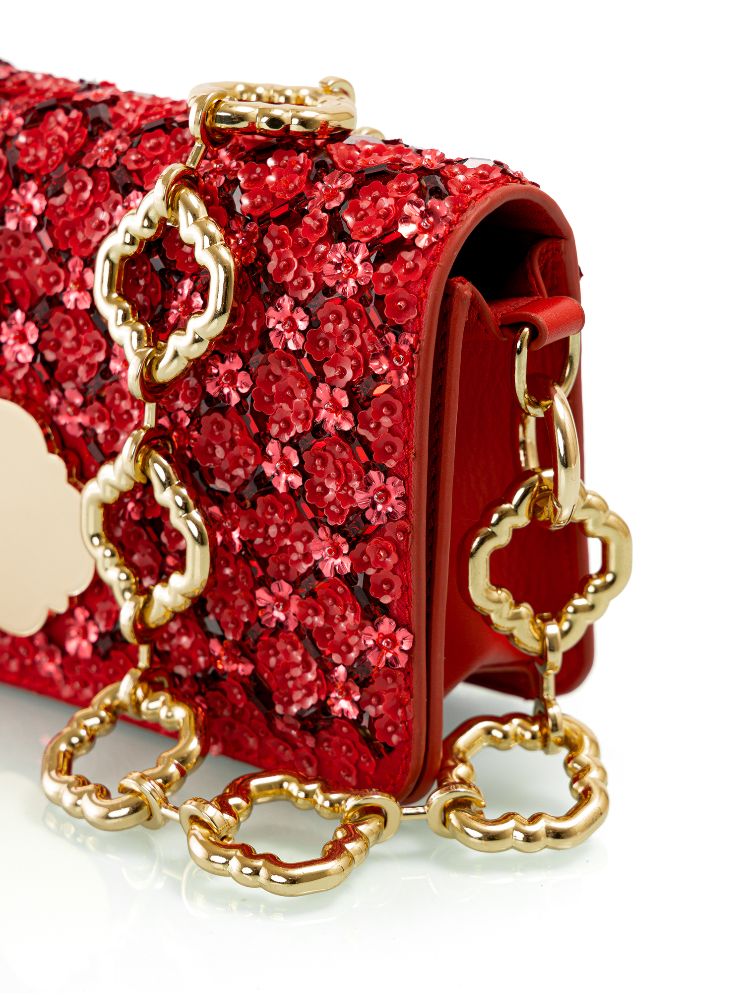 Embellished crimson leather handbag featuring intricate detailing for elegant evening wear
