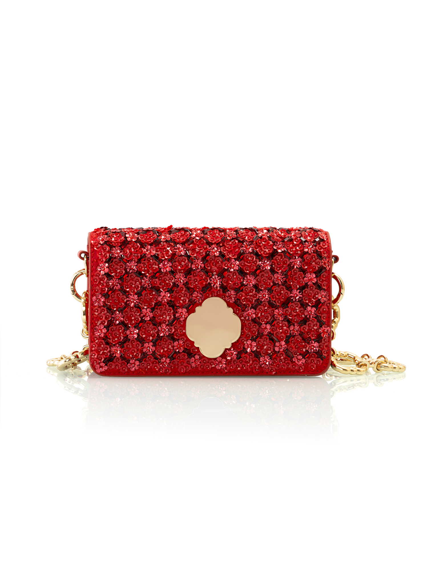 Close-up of red crystal embellishment on a crimson embroidered leather handbag
