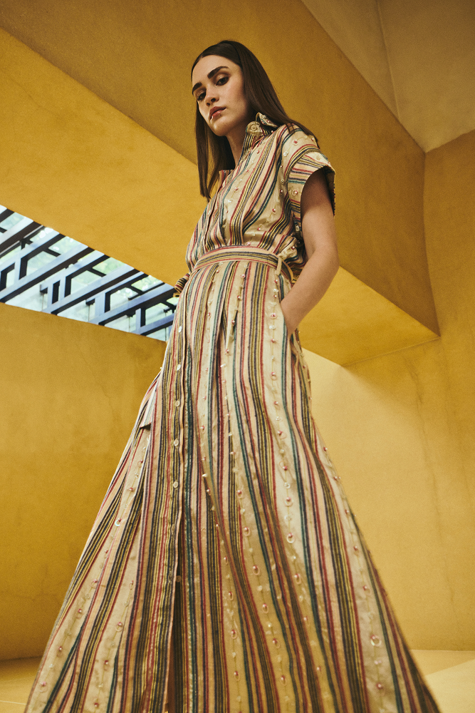 Vacation shirt dress styled as a sleeveless shirt dress for relaxed daytime occasion wear