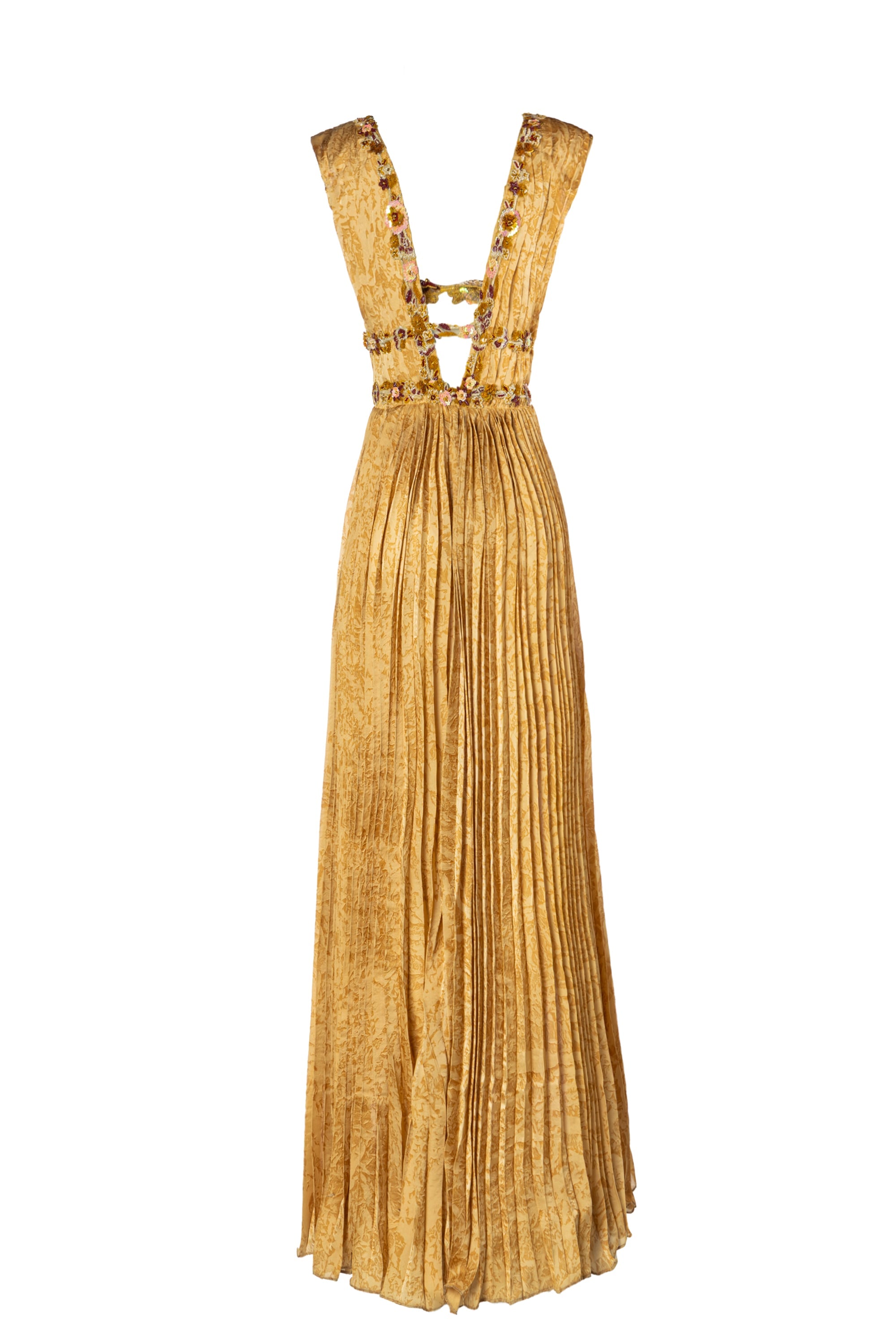 Gold pleated dress with embellishments on a white background