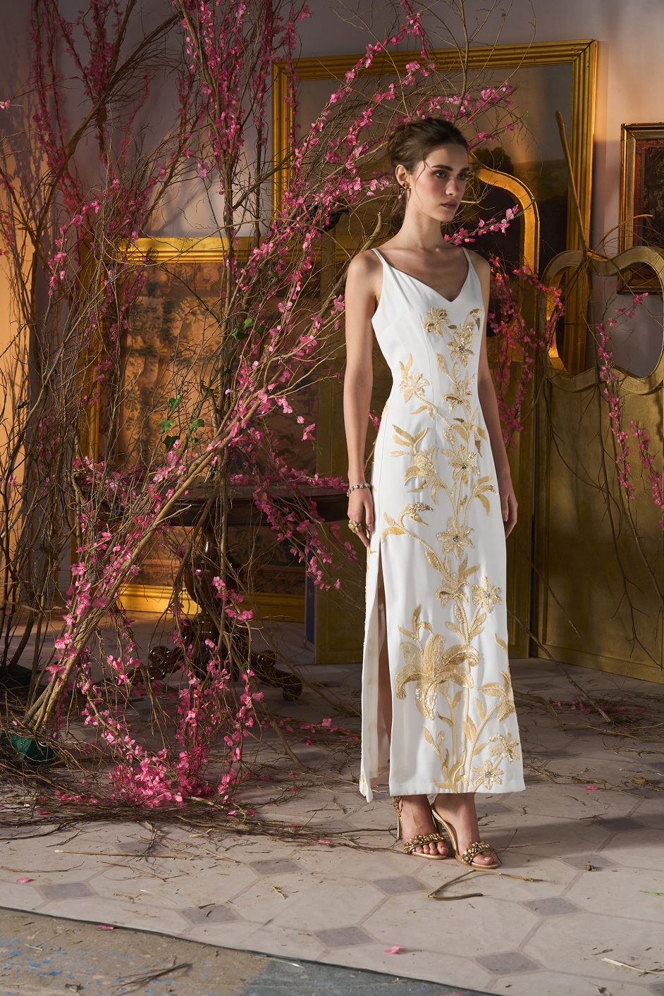 Ivory evening dress featuring intricate floral embroidery for a luxurious statement look.