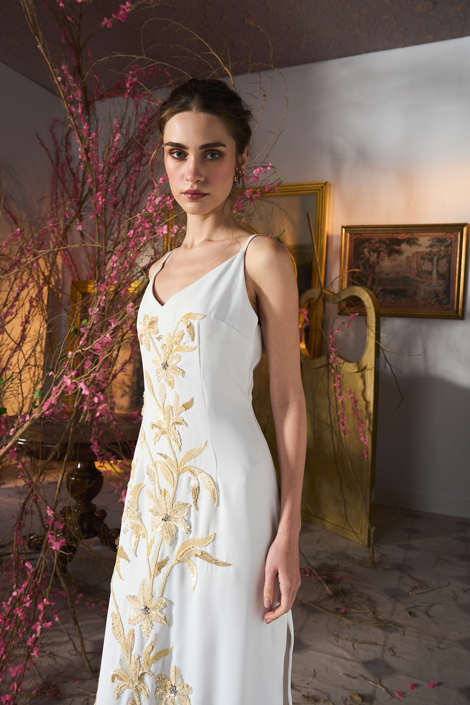 White floral embroidered maxi dress with elegant sequin detailing and a sleek column silhouette.