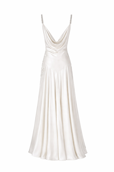 An ivory satin maxi dress with a cowl neckline, thin straps adorned with rhinestones, and a flared skirt, shown against a plain white background.