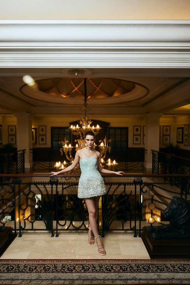 Destination party outfit featuring a refined sleeveless mini silhouette
