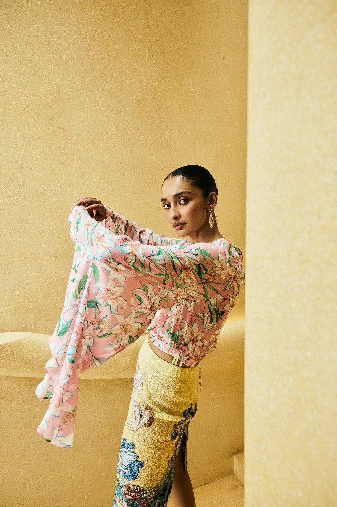 Long flared sleeve top styled for summer event fashion and resort party wear
