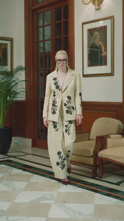 Close-up view of embroidery work on a model’s designer embroidered dress.