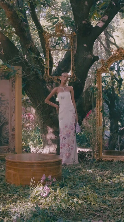 High fashion formal gown combining a sleek column silhouette with soft pastel luxury accents