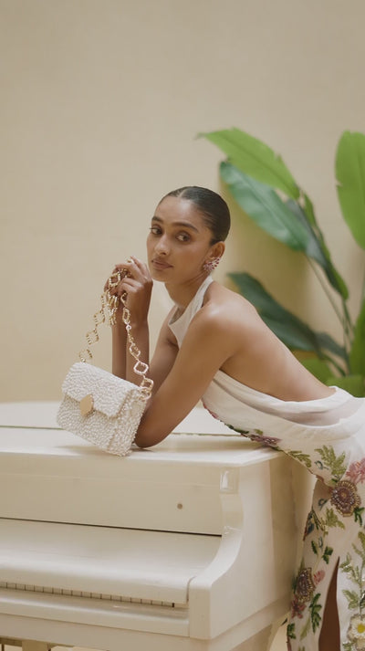 Close-up of a model showcasing detailed hand embroidery on a designer evening dress